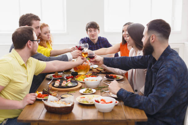 istock People say cheers clink glasses at festive table dinner party 832001124