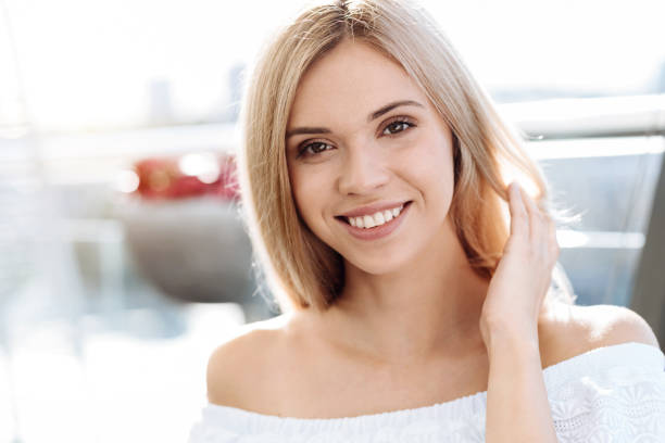 istock Attractive pretty woman fixing her hair 832017216