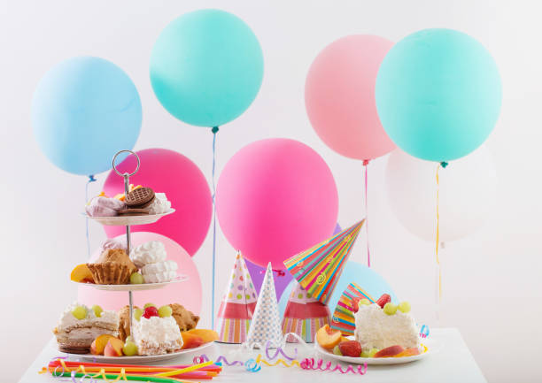 istock Birthday celebration with cake and colorful balloons 832018006