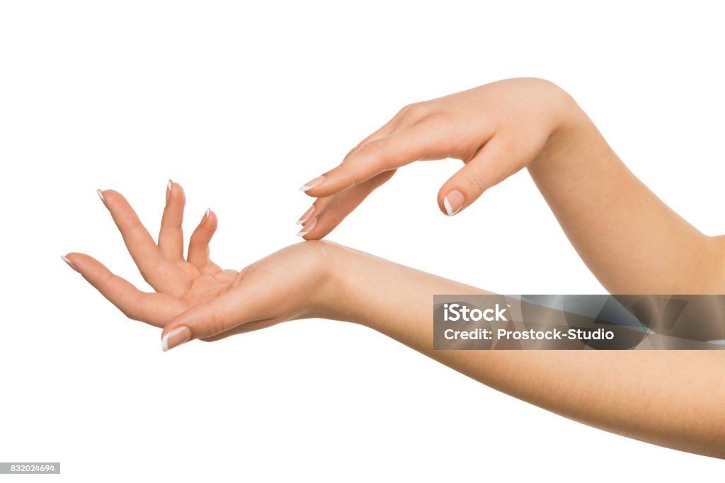 Female hands with french manicure, crop, cutout Beauty and skincare concept - beautiful female hands with french manicure, woman touching skin after spa treatment isolated on studio white background, close-up, cutout Hand Stock Photo