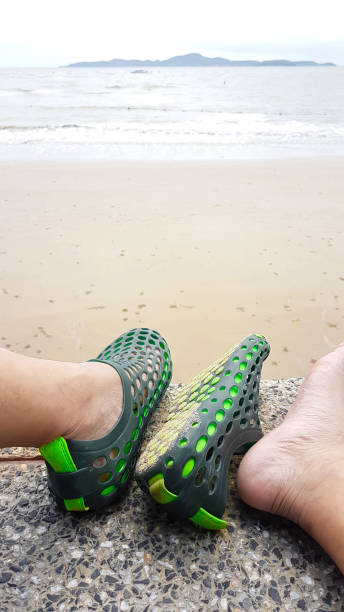 istock Relaxed of man with hole shoe beside the beach 832026152