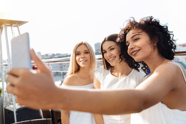 istock Pleasant brunette woman holding a smartphone 832031608