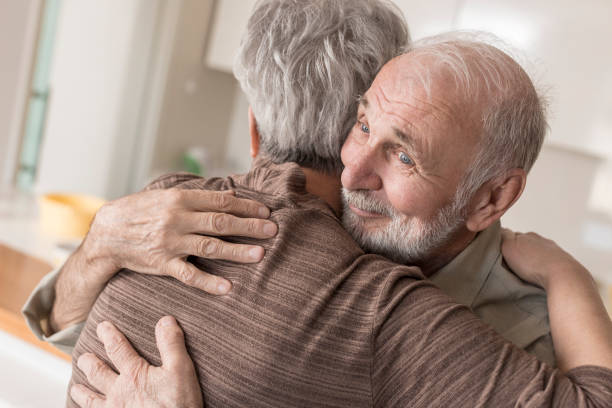 istock Senior couple hugging at home 832031786