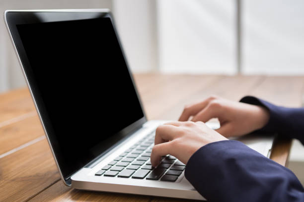 istock Business woman using laptop at workplace, close-up 832032470