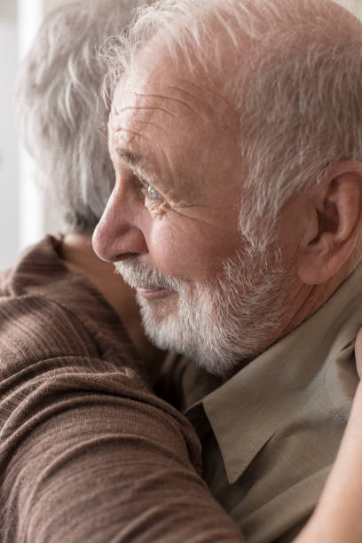 istock Senior couple hugging at home 832032754
