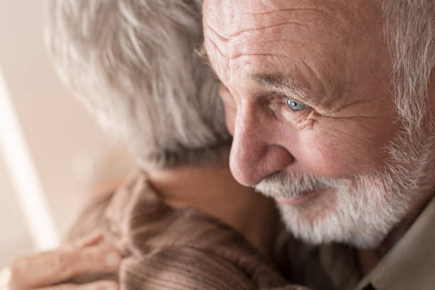 istock Senior couple hugging at home 832032928