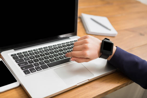 istock Close-up of woman using smart watch at workplace 832033128