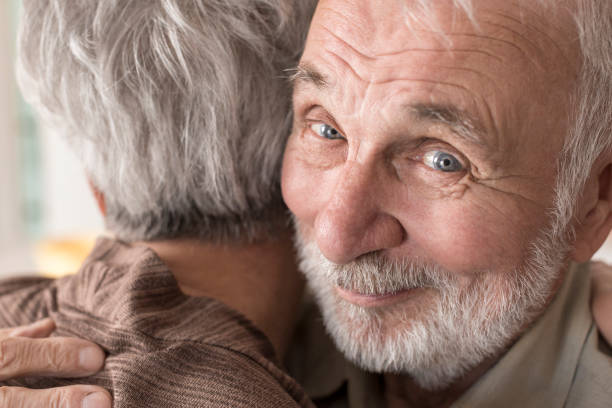 istock Senior couple hugging at home 832033402