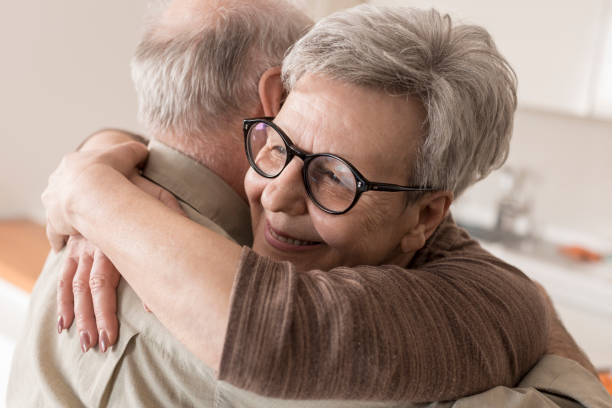 istock Senior couple hugging at home 832033614