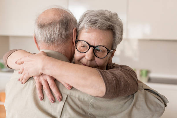 istock Senior couple hugging at home 832034104