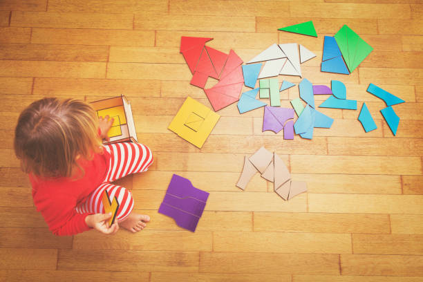 istock little girl playing with puzzle, learning 832036648