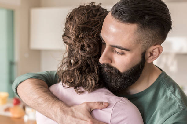 istock Couple hugging in living room 832042276