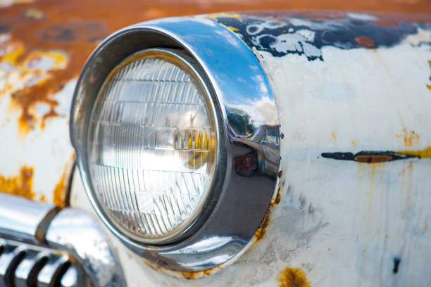 istock Headlight of a rusty old vintage white car 832048158