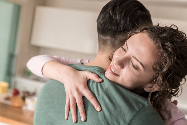 istock Couple hugging in living room 832048352