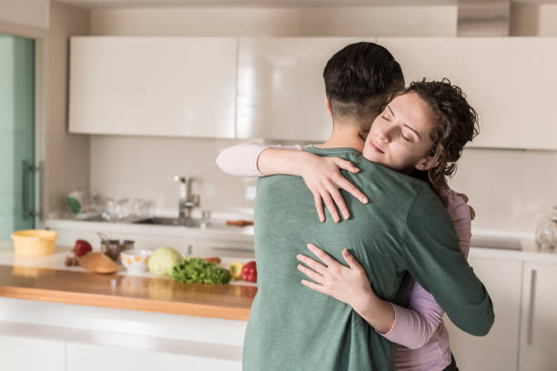 istock Couple hugging in living room 832048562