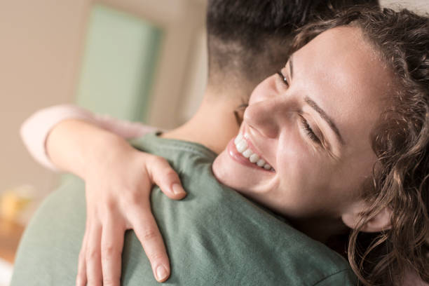 istock Couple hugging in living room 832048940
