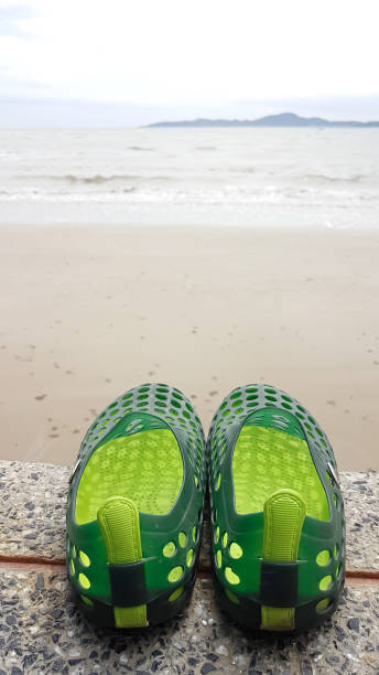 istock hole silicone shoe on the marble floor with beach view 832049534