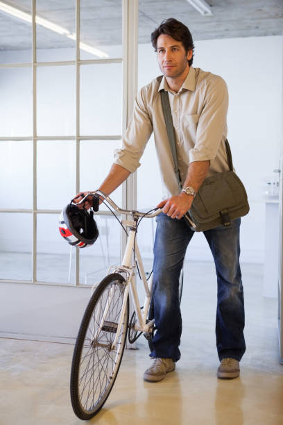 istock Casual businessman pushing his bike 832072064