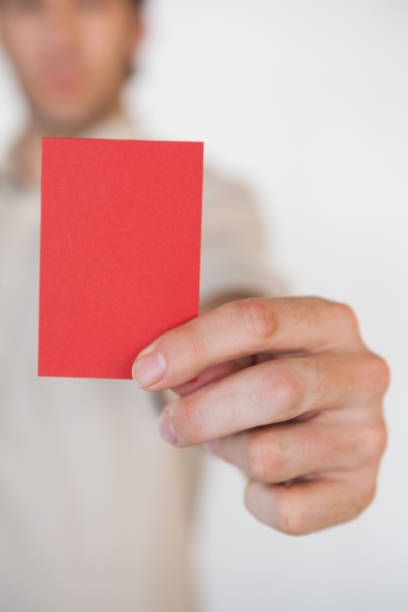 istock Casual businessman showing red card 832072698