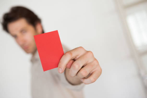 istock Casual businessman showing red card 832072726