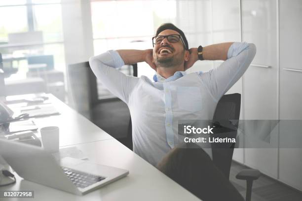 Business Man Sitting In Office And Stretched Business Man Having Break Stock Photo - Download Image Now