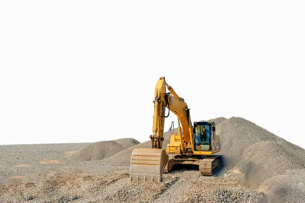 the image Tracked excavator on a construction site among piles of rubble isolated
