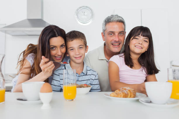 istock Cheerful family eating breakfast together 832073616