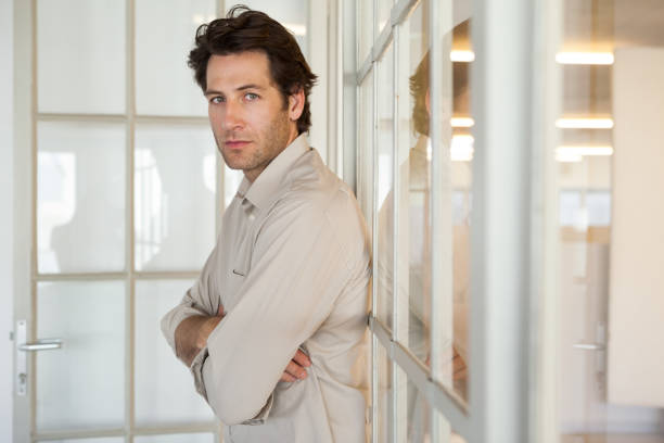istock Casual worried businessman leaning on window 832073864