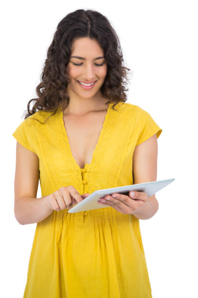 istock Cheerful casual young woman scrolling on her tablet computer 832074536