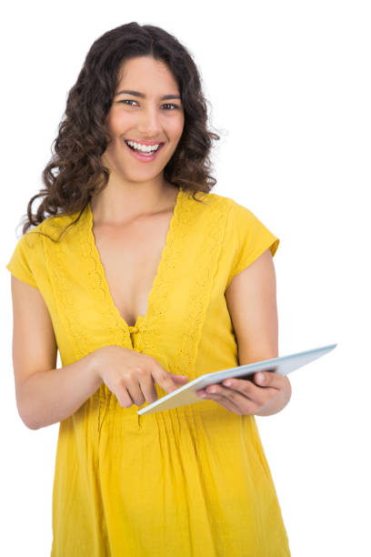 istock Smiling casual young woman scrolling on her tablet computer 832074680