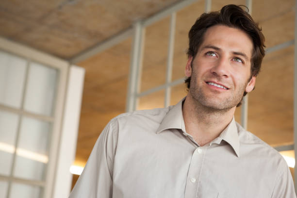 istock Casual businessman thinking and smiling 832074782