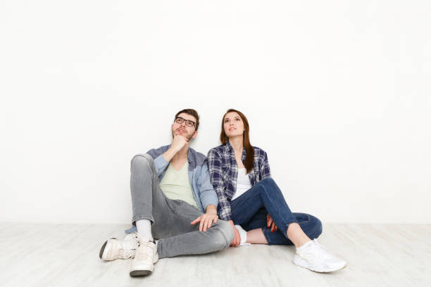 istock Couple looks up at white background 832075122