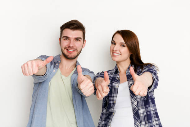 istock Funny couple with thumbs up gesture, studio shot 832081248