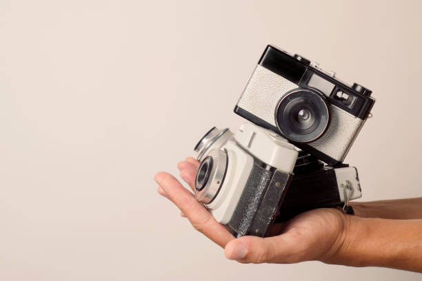 istock young man with old film cameras 832081284