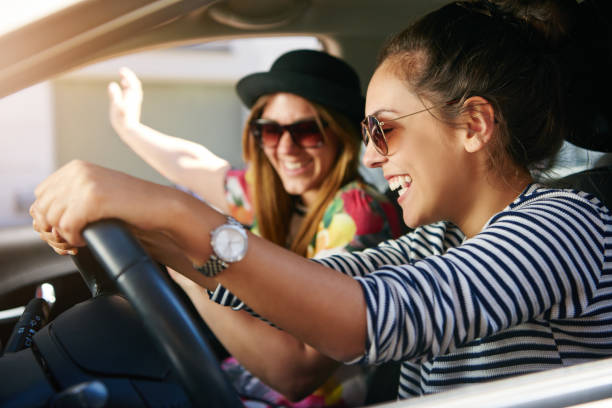 istock Two smiling young friends driving on a road trip together 832085206