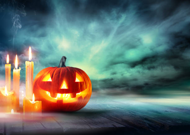 istock Halloween Celebration - Pumpkin And Candles On Table 832088314