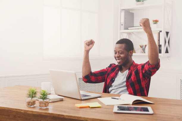 istock Happy businessman win. Winner, black man in office 832088850