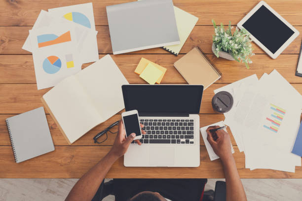 istock African-american businessman at work, table top view 832089284