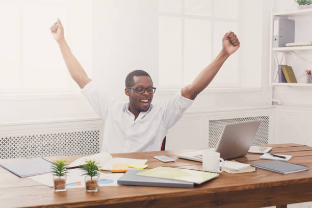 istock Happy businessman win. Winner, black man in office 832089514