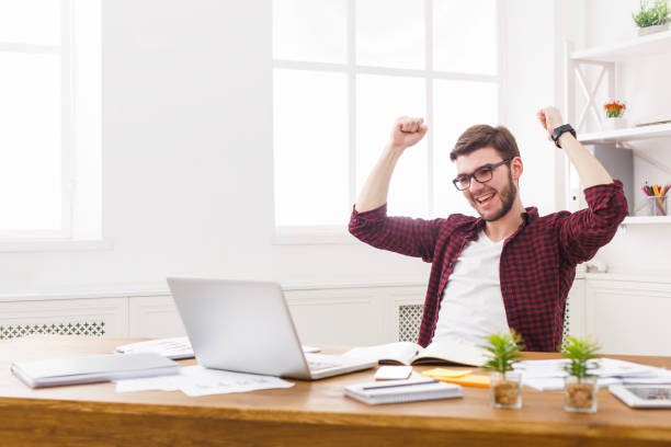 istock Young happy businessman in office with computer 832091938
