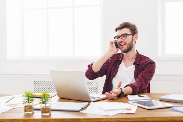 istock Young businessman has a mobile talk in modern white office 832092406
