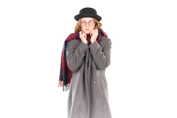 Portrait of teenage hispter girl wearing gray overcoat and black hat isolated on white