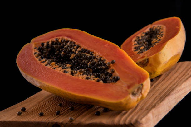 istock Freshness papaya fruit on the wooden rustic plank and black background. 832096512
