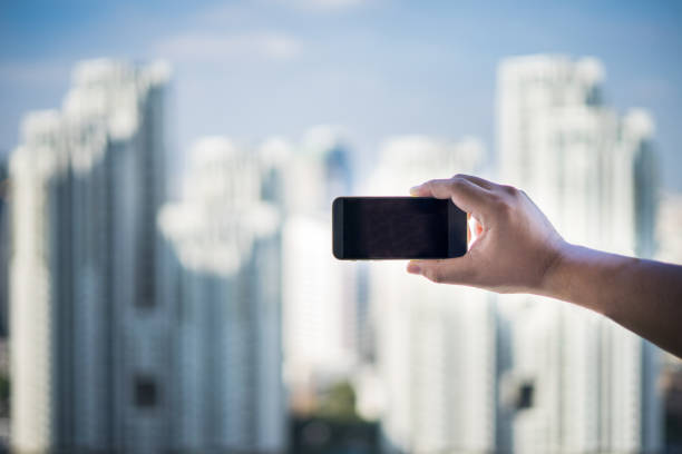 istock hand hold smart phone, cell phone, mobile over blurred image 832096924