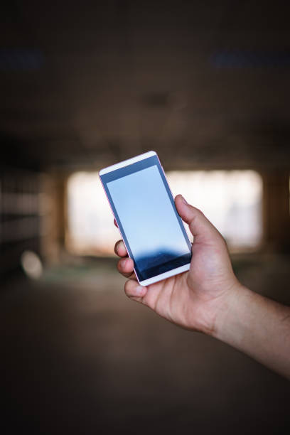 istock hand hold smart phone, cell phone, mobile over blurred image 832096952