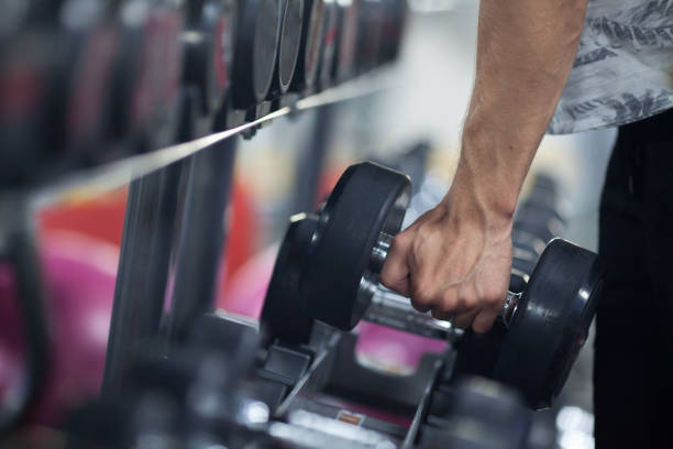 istock Man holding dumbbell in gym 832099694