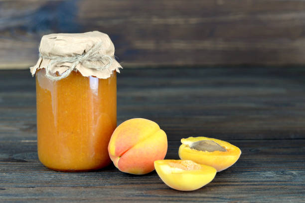 Apricot jam on wooden table
