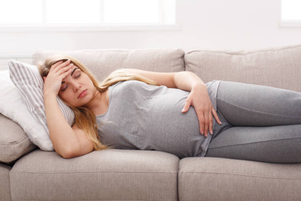istock Young expectant blonde with headache copy space 832101566