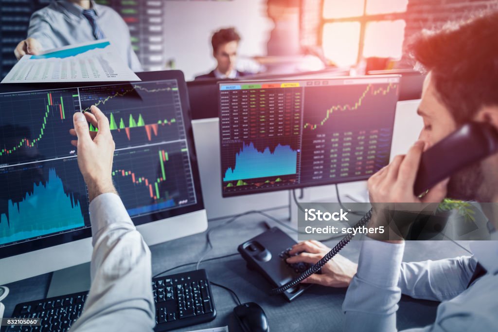 Business team deal on a stock exchange. Stock traders concept. Business team investment trading do this deal on a stock exchange. People working in the office. Stock Market and Exchange Stock Photo