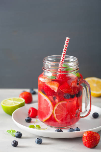 istock summer berry lemonade with lime and mint in mason jar 832105132